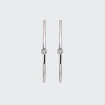 A pair of minimalist Odyssey Silver Hoops, each featuring a single bezel-set diamond on the front-facing side.