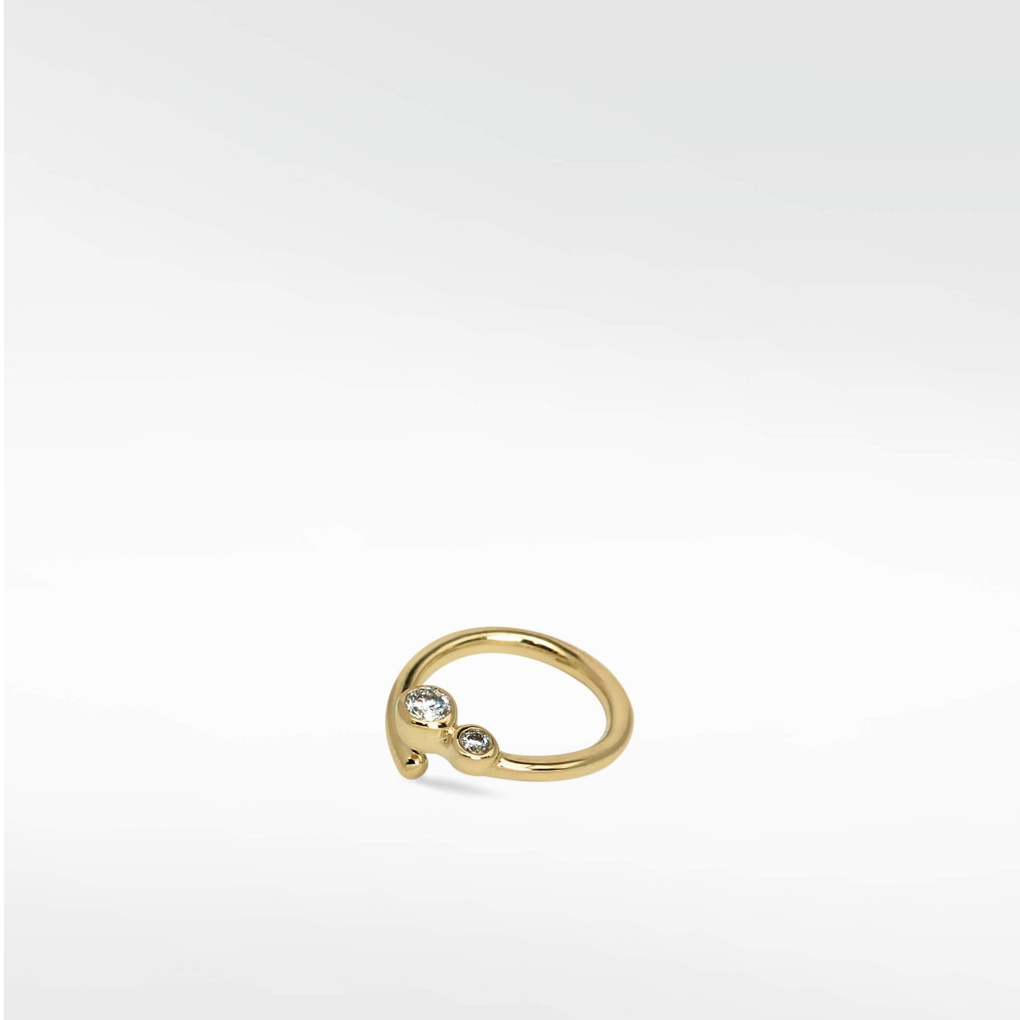 The Interstellar Nocturnal Curative Hoop earring in yellow gold, featuring two bezel-set, lab-grown diamonds.