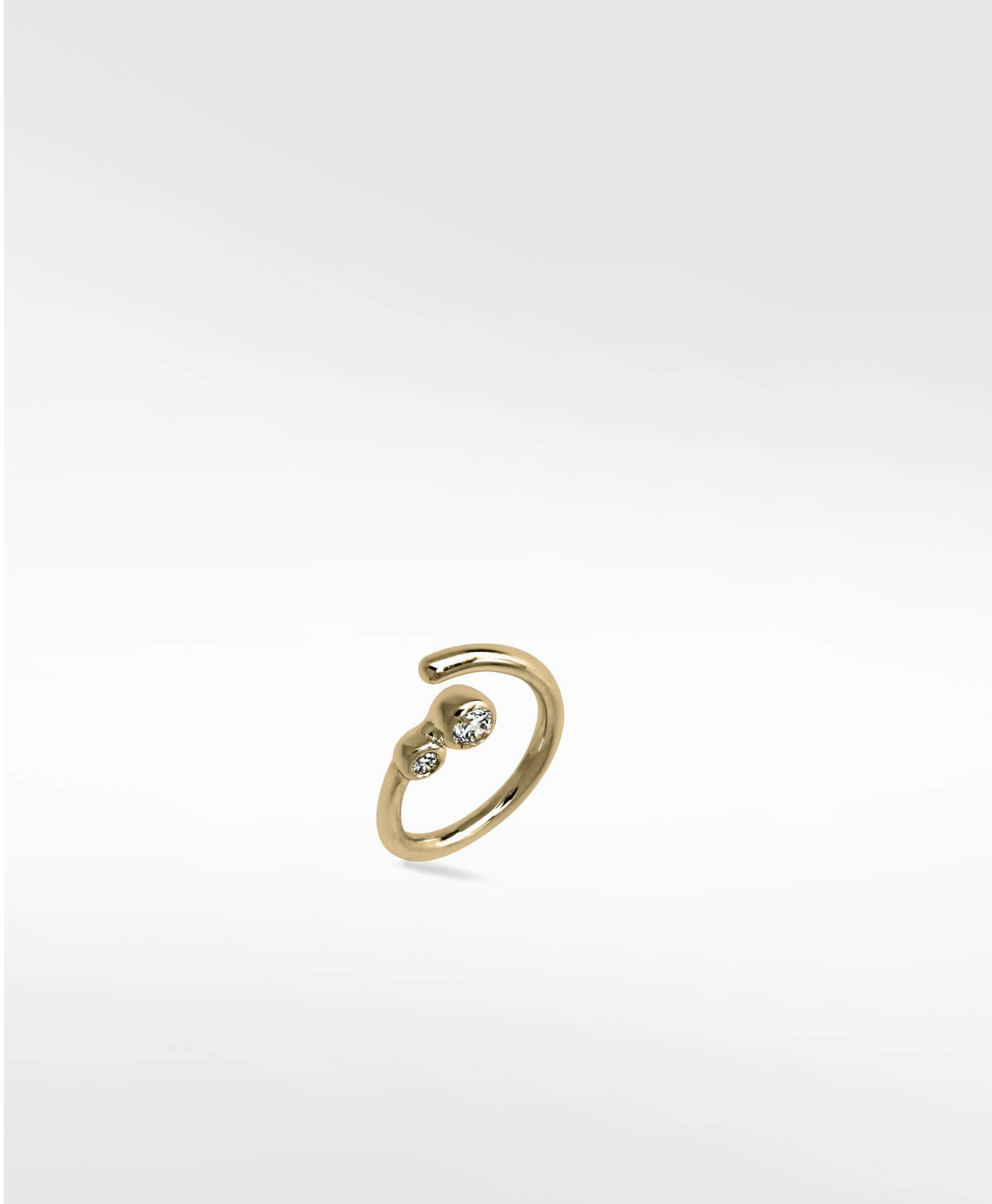 Interstellar Nocturnal Curative Hoop in 14K yellow gold with two bezel-set lab diamonds on a white background.