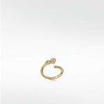 A delicate yellow gold open hoop earring, the Nocturnal Curative Hoop, featuring two bezel-set diamonds at one end.