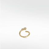 A delicate yellow gold open hoop earring, the Nocturnal Curative Hoop, featuring two bezel-set diamonds at one end.